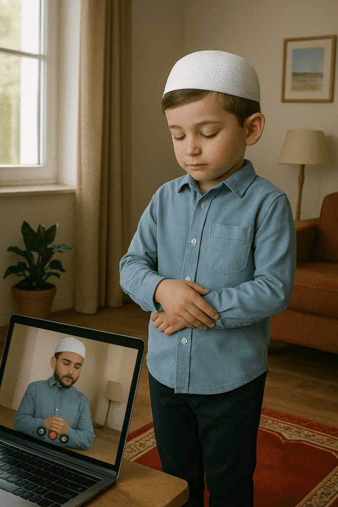 Young boy performing Salah while following an online tutor on a laptop screen.