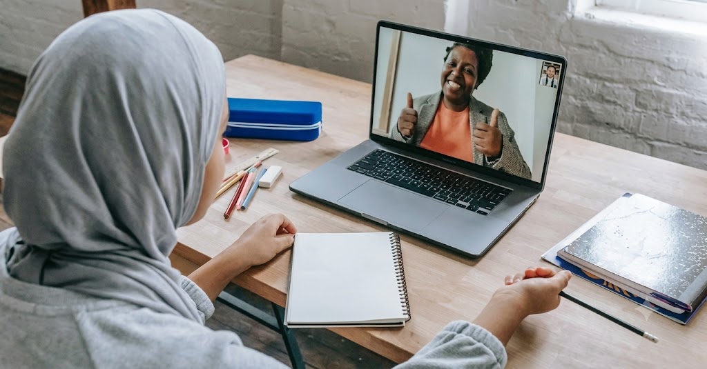 Young student taking a 1-on-1 online tuition class on a laptop at home