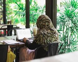 Child studying curriculum coursework and online lessons at desk